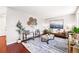 Bright living room with modern furnishings, stylish decor, and a large window for natural light at 5202 Dillon St, Denver, CO 80239