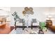 Cozy living area featuring modern decor, stylish seating, and ample natural light at 5202 Dillon St, Denver, CO 80239