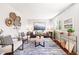 Bright living room with modern furnishings, stylish decor, and a large window for natural light at 5202 Dillon St, Denver, CO 80239
