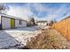 Large backyard with detached garage and wooden fence at 1846 S Lowell Blvd, Denver, CO 80219