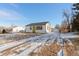 Charming Ranch home exterior, featuring a green door and attached garage at 1846 S Lowell Blvd, Denver, CO 80219