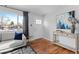 Bright living room with hardwood floors and comfy seating at 1846 S Lowell Blvd, Denver, CO 80219