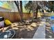Backyard area featuring a wooden fence, bench, and sidewalk at 2213 S Meade Street, Denver, CO 80219