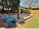 Backyard area featuring a stone patio, pergola, and colorful outdoor play mats at 2213 S Meade Street, Denver, CO 80219