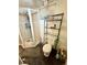 Cozy bathroom featuring a corner shower with glass door and black storage shelves at 2213 S Meade Street, Denver, CO 80219