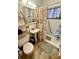 Bathroom with a toilet, shower, sink, and storage shelves at 2213 S Meade Street, Denver, CO 80219