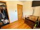 Bedroom with hardwood floors, closet, wood door and TV at 2213 S Meade Street, Denver, CO 80219
