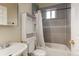 Bathroom featuring a shower/tub combo, with gray tile and a shower curtain at 4024 W Kentucky Ave # A And B, Denver, CO 80219