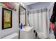 Bathroom with a vanity, framed mirror, and a shower with curtain at 4024 W Kentucky Ave # A And B, Denver, CO 80219
