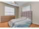 Bedroom featuring light walls, hardwood floors, and a grey upholstered headboard at 4024 W Kentucky Ave # A And B, Denver, CO 80219