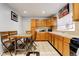 Eat-in kitchen featuring wooden cabinets, tile countertops, and tile flooring at 4024 W Kentucky Ave # A And B, Denver, CO 80219