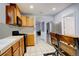 Eat-in kitchen featuring wooden cabinets, stainless steel appliances, and tile flooring at 4024 W Kentucky Ave # A And B, Denver, CO 80219