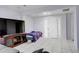 Living room with white walls, tile floors, and a bright white front door at 4024 W Kentucky Ave # A And B, Denver, CO 80219