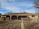 The backyard has a covered patio with a fenced yard, ideal for outdoor relaxation and privacy at 1390 Ash Ct, Thornton, CO 80229