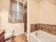Bathroom featuring a tub with a tiled shower and light beige walls at 11316 Colony Cir, Broomfield, CO 80021