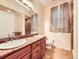 Bright bathroom boasts a double sink vanity with granite counters and a tiled shower at 11316 Colony Cir, Broomfield, CO 80021