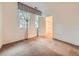 Bright bedroom featuring large windows, neutral carpet, and a walk-in closet at 11316 Colony Cir, Broomfield, CO 80021