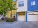 Townhouse garages featuring colorful exteriors and manicured shrubbery at 11316 Colony Cir, Broomfield, CO 80021