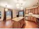 Open-concept living space featuring a large island kitchen with stainless steel appliances and hardwood floors at 11316 Colony Cir, Broomfield, CO 80021