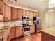 Stainless steel appliances accent this kitchen with a tile backsplash and wood cabinets at 11316 Colony Cir, Broomfield, CO 80021