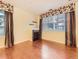 Living room featuring a fireplace, hardwood floors, and a large window with blinds and curtains at 11316 Colony Cir, Broomfield, CO 80021