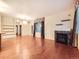 Open concept living room with hardwood floors, a fireplace with tile, and a large window at 11316 Colony Cir, Broomfield, CO 80021