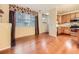 Hardwood floors highlight an open-concept living space featuring a kitchen, a fireplace, and large windows at 11316 Colony Cir, Broomfield, CO 80021