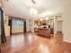 Spacious living room with hardwood floors and a modern kitchen area featuring stainless steel appliances at 11316 Colony Cir, Broomfield, CO 80021