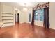 Bright living room featuring hardwood floors, a built-in bookcase, and a door to a patio at 11316 Colony Cir, Broomfield, CO 80021