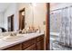 Clean bathroom with a shower/tub combo and wood vanity at 4251 S Fairplay Cir # E, Aurora, CO 80014