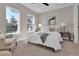 Bright bedroom features two large windows, neutral walls, plush carpet, and comfortable furnishings at 2140 S Ash St # 104, Denver, CO 80222