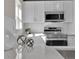 Bright kitchen featuring white cabinetry, stainless steel appliances, and elegant countertops at 2140 S Ash St # 104, Denver, CO 80222