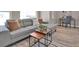 Comfortable living room featuring a sectional couch, stylish coffee tables, and natural light at 2140 S Ash St # 104, Denver, CO 80222