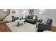 Finished basement with gray sofa, armchairs, and hardwood floors at 1445 Elm St, Denver, CO 80220