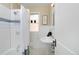 Clean bathroom with white subway tiles, pedestal sink, and shower/tub at 1445 Elm St, Denver, CO 80220