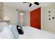 Bedroom with king-size bed, orange closet, and ceiling fan at 1445 Elm St, Denver, CO 80220