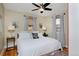 Bright bedroom with king-size bed, hardwood floors, and ceiling fan at 1445 Elm St, Denver, CO 80220