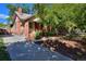 Brick home with landscaped yard and a driveway at 1445 Elm St, Denver, CO 80220