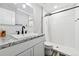 Modern bathroom with white subway tile, granite vanity, and walk-in shower at 11220 Keota St, Parker, CO 80134