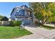 Two-story blue home with a two-car garage and basketball hoop at 11220 Keota St, Parker, CO 80134