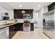 Modern kitchen with stainless steel appliances and dark cabinetry at 11220 Keota St, Parker, CO 80134