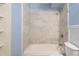 Clean bathroom with beige tile and light blue walls at 3663 S Sheridan Blvd # 2, Denver, CO 80235