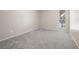 Empty bedroom features neutral carpet, walls, baseboards, and a sunlit window at 3663 S Sheridan Blvd # 2, Denver, CO 80235