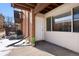 Exterior front door of the building, featuring a small patio and brick facade at 3663 S Sheridan Blvd # 2, Denver, CO 80235