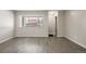 Living room with gray vinyl flooring and large window at 3663 S Sheridan Blvd # 2, Denver, CO 80235