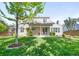 Expansive backyard with patio, mature trees, manicured lawn and partial fence at 6829 S Niagara Ct, Centennial, CO 80112