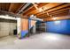 Unfinished basement with exposed wood beams and utilities, offering potential for customization at 6829 S Niagara Ct, Centennial, CO 80112