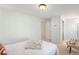 Airy bedroom with white bedding, neutral accents and light green walls at 6829 S Niagara Ct, Centennial, CO 80112