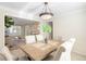 Bright dining room with a stylish light fixture and views into the adjacent living room at 6829 S Niagara Ct, Centennial, CO 80112