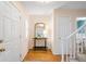Bright entryway with hardwood floors, elegant mirror, and a staircase leading to the upper level at 6829 S Niagara Ct, Centennial, CO 80112